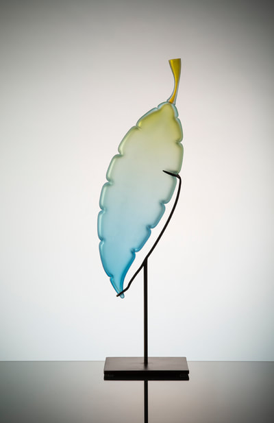 Michael Schunke handblown glass sculpture. Glass leaf, blue glass, blue-green glass sculpture, yellow green blue glass, studio glass, art glass. Colorful blown glass.